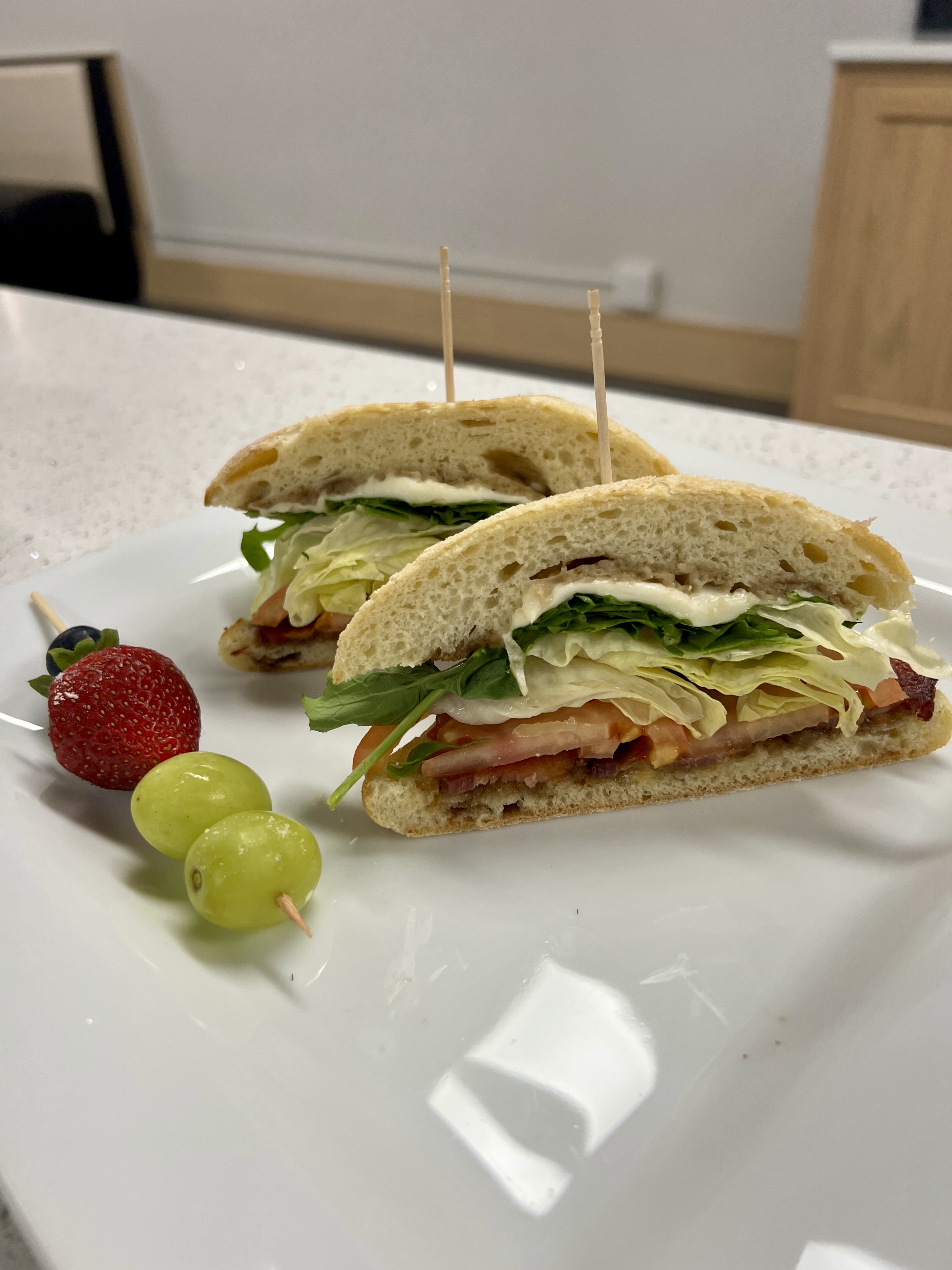 Breakfast sandwich on sourdough served with fresh fruit at Milk & Honey, Westby WI