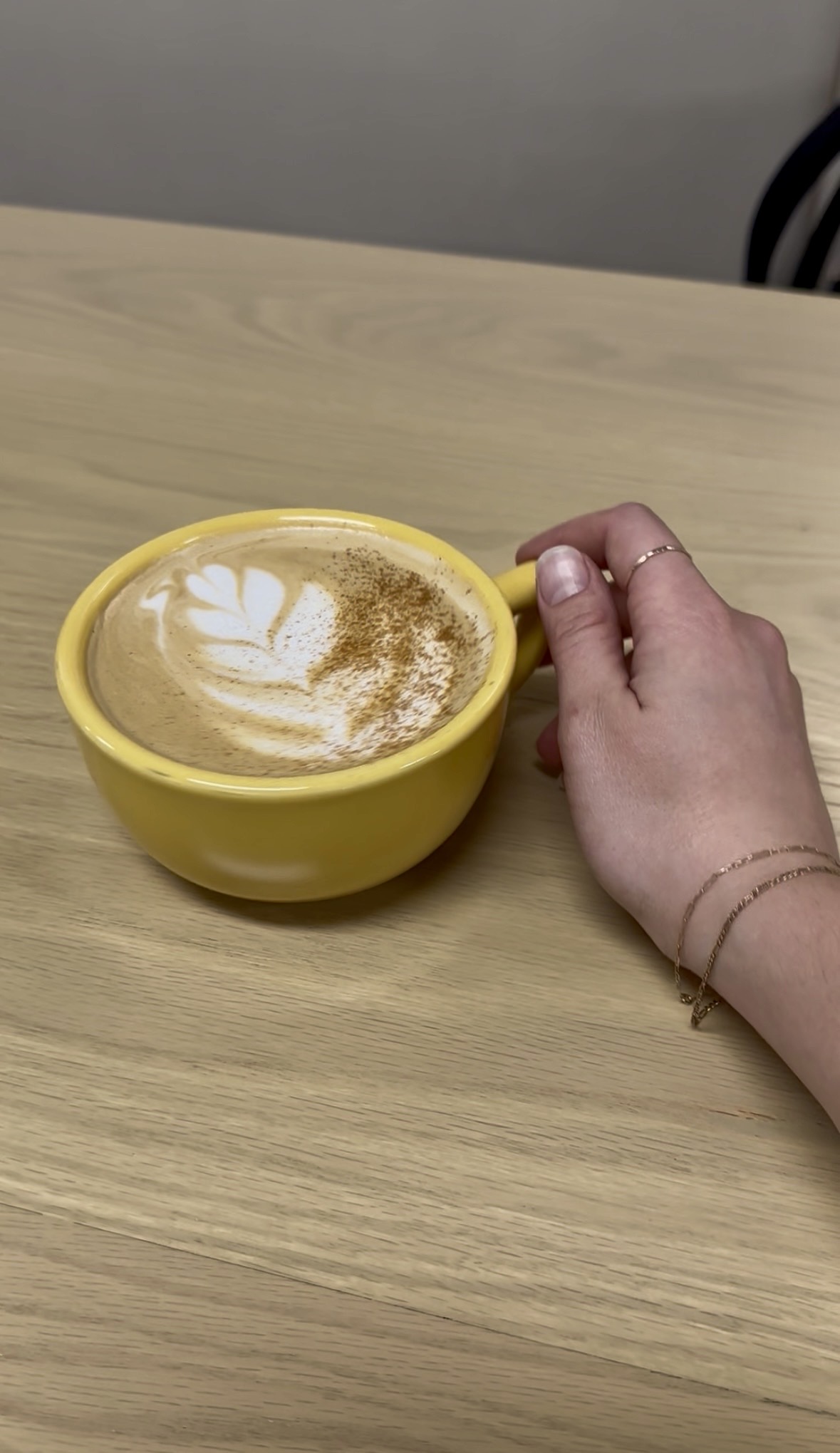 A creamy latte in a golden mug at Milk & Honey Espresso Bar